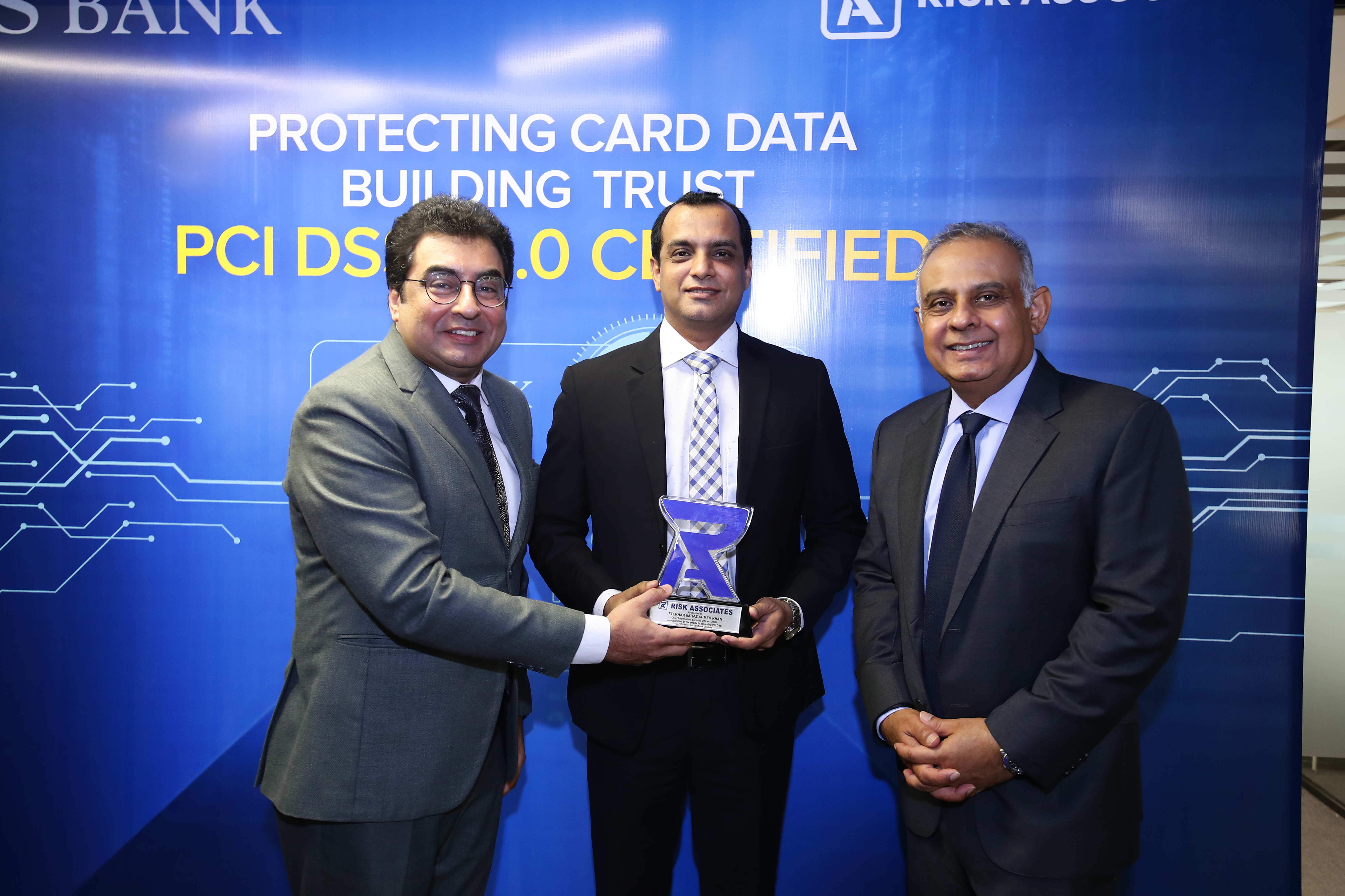Mr. Aziz Rahim – COO of Risk Associates presented the PCI DSS Certificate of Compliance to Mr. Basir Shamsi – President & CEO of JSBL, at the ceremony.
